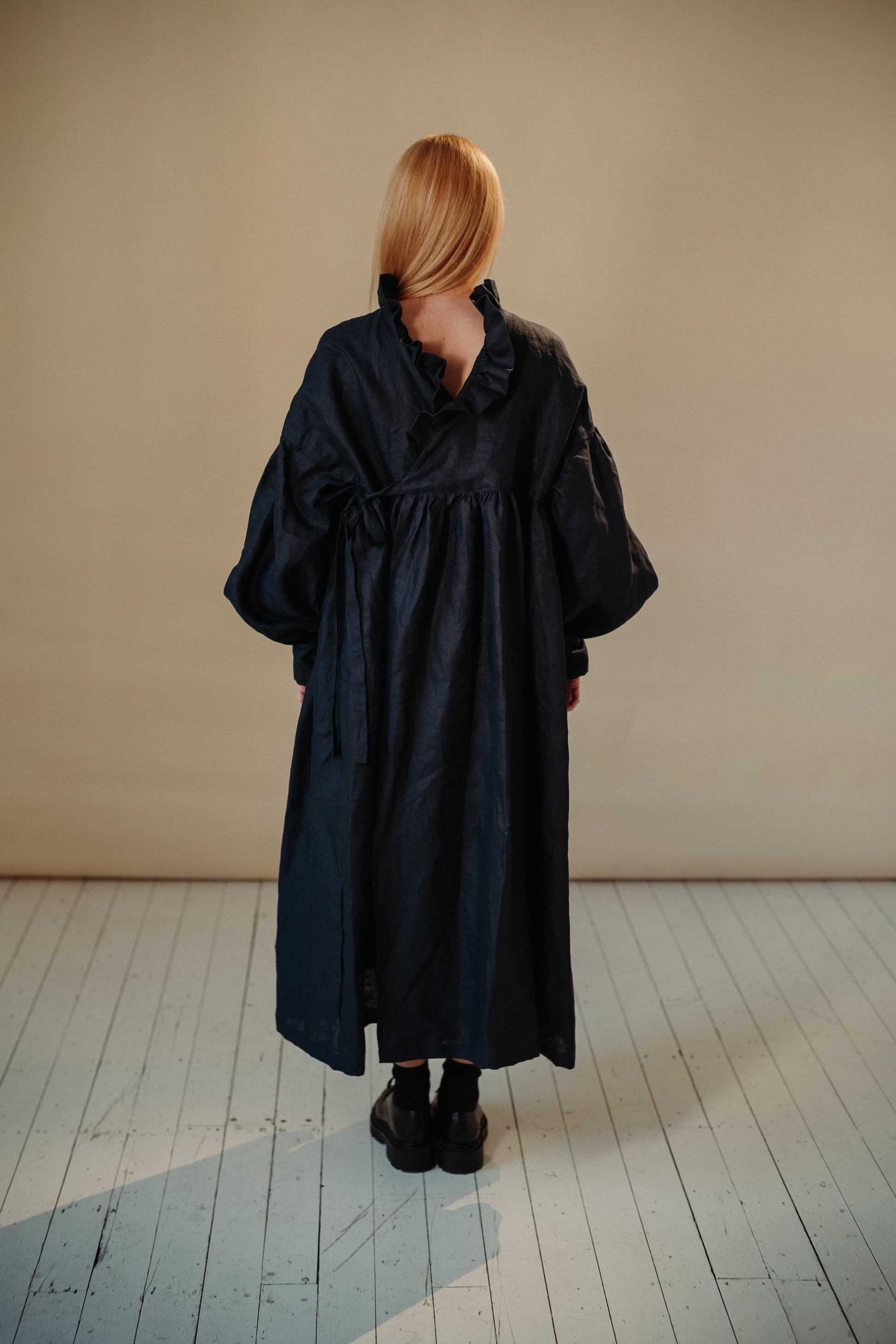 CAMILLE DRESS | NAVY | She has become one of our signature pieces, so we thought it only right to offer a wintery navy version. Camille is a delight to wear. A wrap dress that features a ruffle collar, balloon sleeves and a bow cuff detail. The dress can