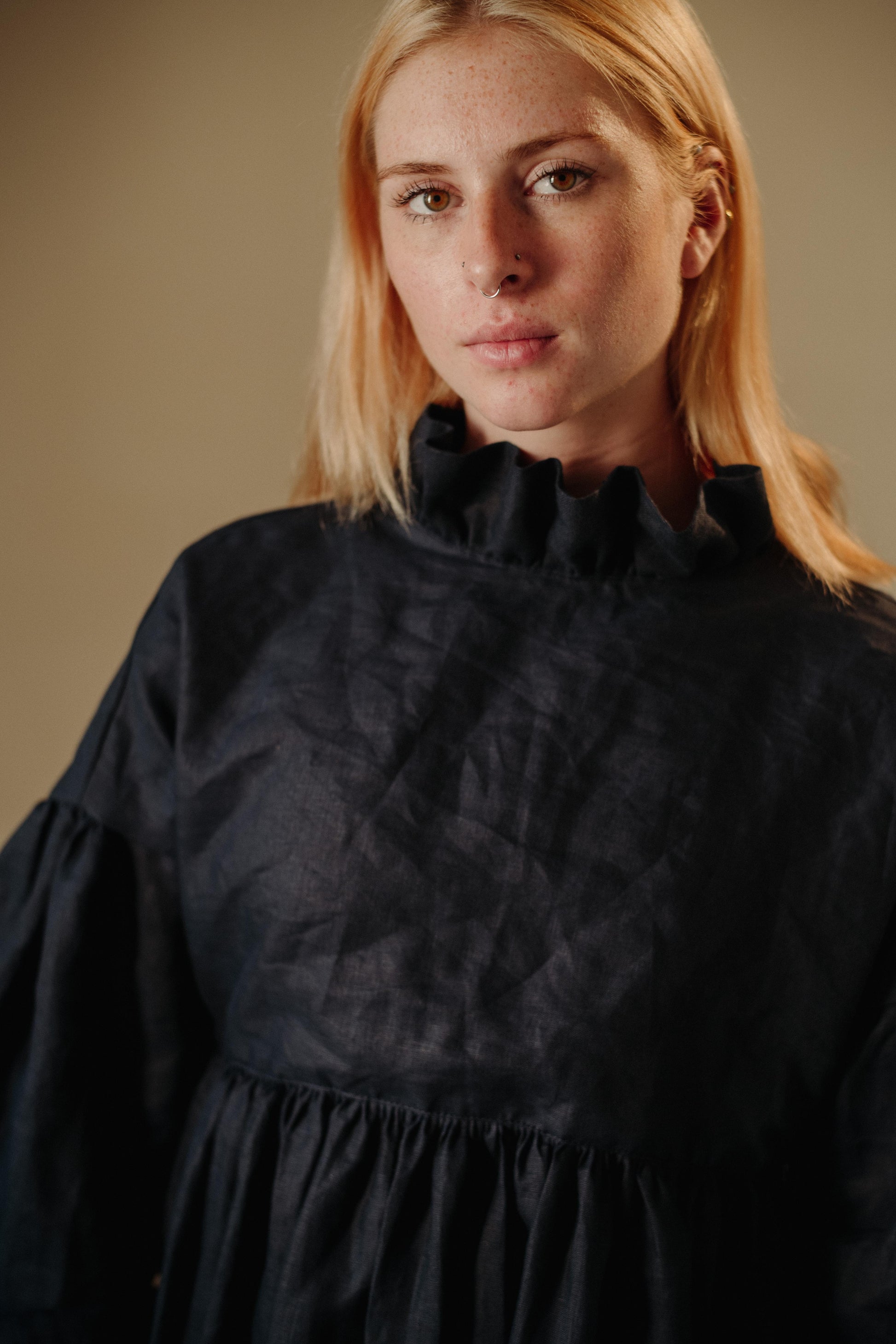 CAMILLE DRESS | NAVY | She has become one of our signature pieces, so we thought it only right to offer a wintery navy version. Camille is a delight to wear. A wrap dress that features a ruffle collar, balloon sleeves and a bow cuff detail. The dress can