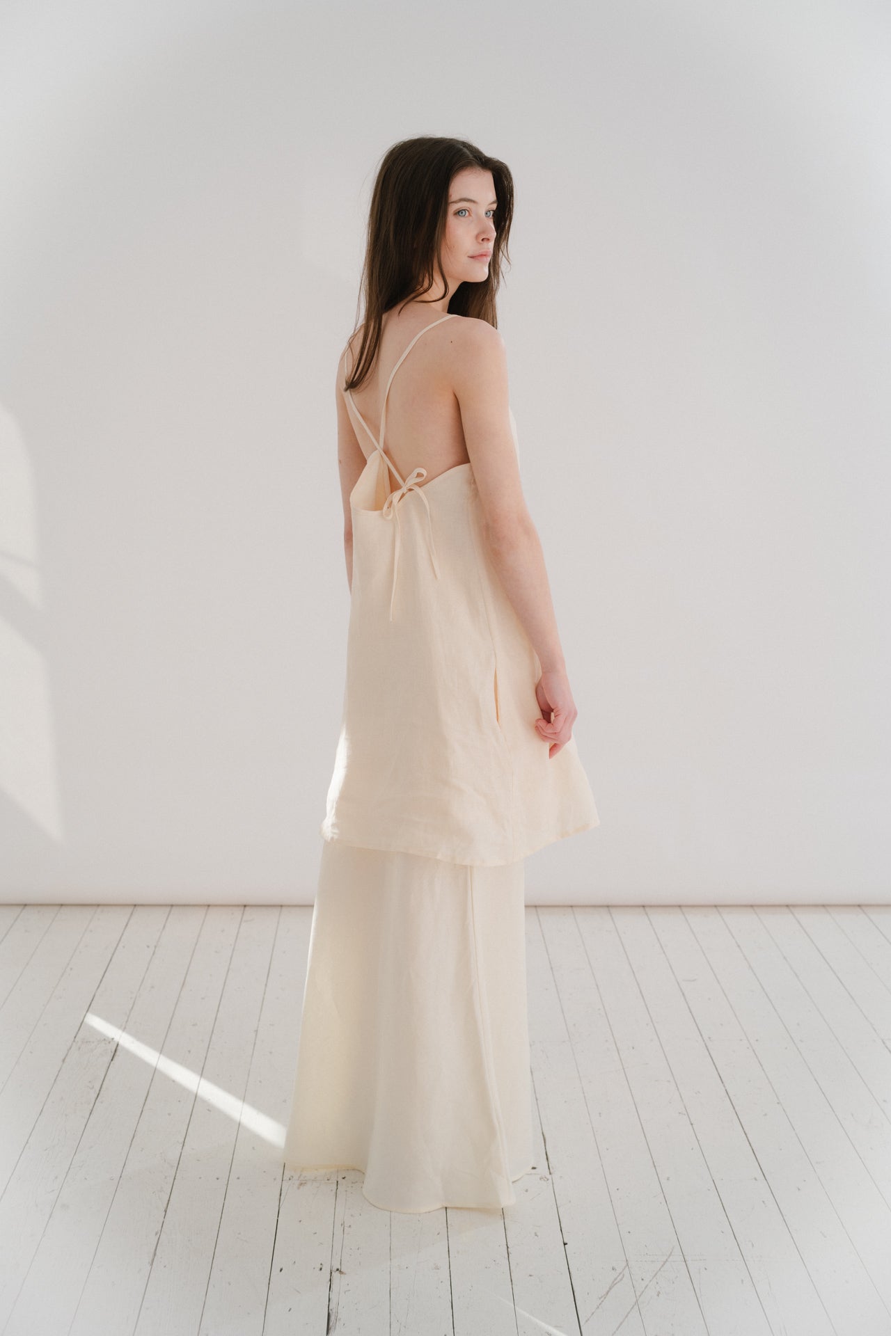 THE ELLA MINI | THE ELLA MINI A new shape for us for SS24, the Ella mini is one of our most simple and paired back silhouettes to date. She features a simple square neckline that cowls slightly. The delicate straps crossover each other at the back and att