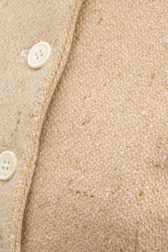 Inheritance Coat in Candlelight Tweed, original campaign macro of the cream wool, gold threads and ivory buttons by Emma Kenny.