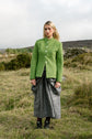 Beetled Bow Skirt in Slate with the Inheritance Blazer in Shamrock, full-length campaign photograph by Emma Kenny.