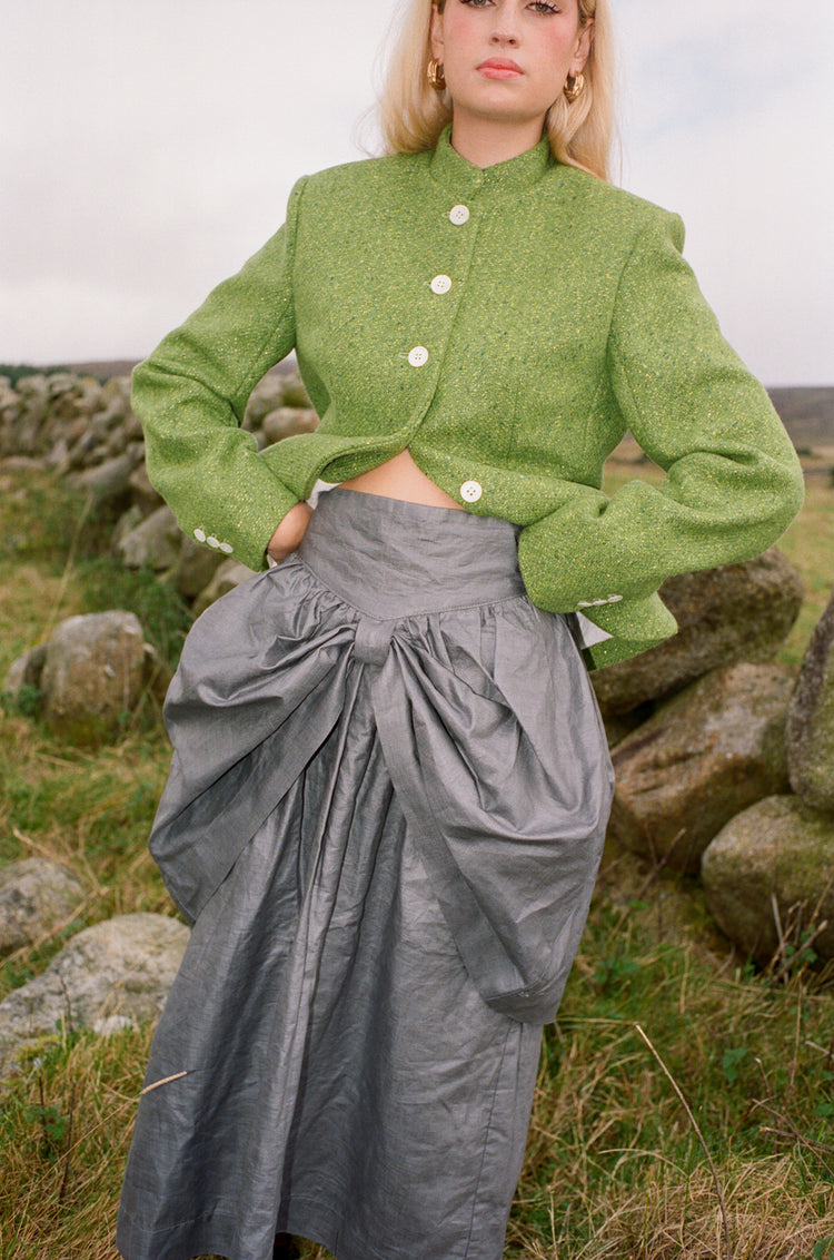 Beetled Bow Skirt in Slate, campaign detail of the shaped waist, bow and lustrous linen by Emma Kenny.