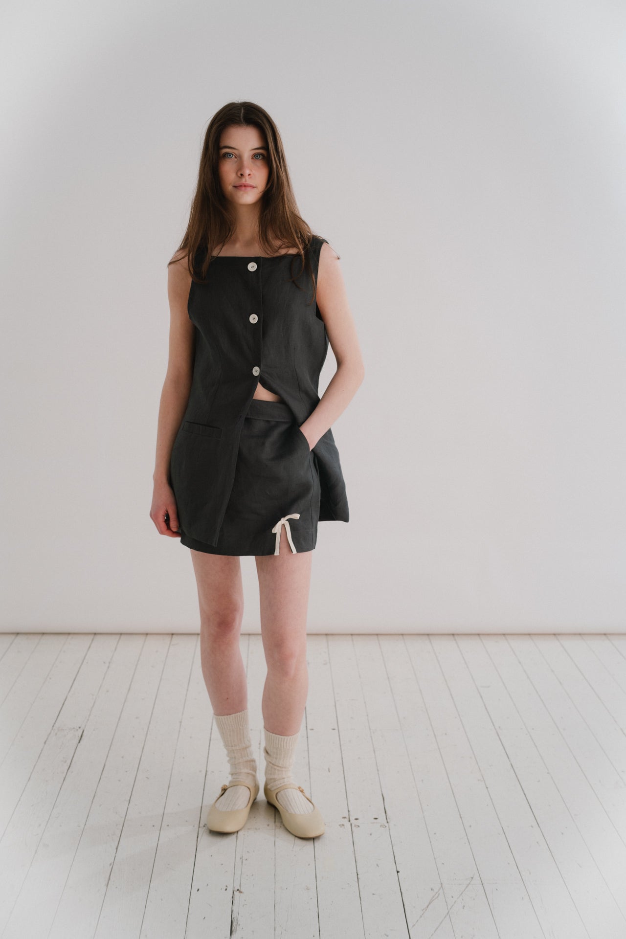 THE MIA MINI - MIDNIGHT | Our very first mini - the Mia skirt has been designed to be the throw on piece that you will continue to reach for this Summer. A delicate bow detail on the front right gives it a little something special. Flat waistband at the f