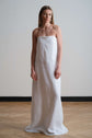Full-length strapless white column dress, photographed front on to show clean lines and minimal silhouette.