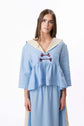 Pale blue dress with sailor-style collar and front ties, shown full length against a clean studio background.