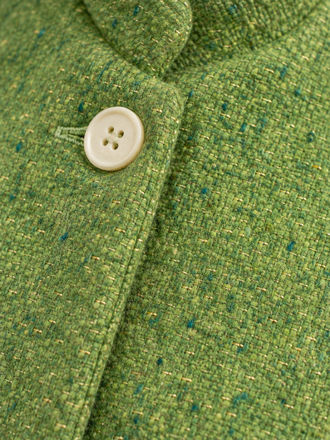 Inheritance Blazer in Shamrock tweed, macro of gold-flecked weave and ivory button.