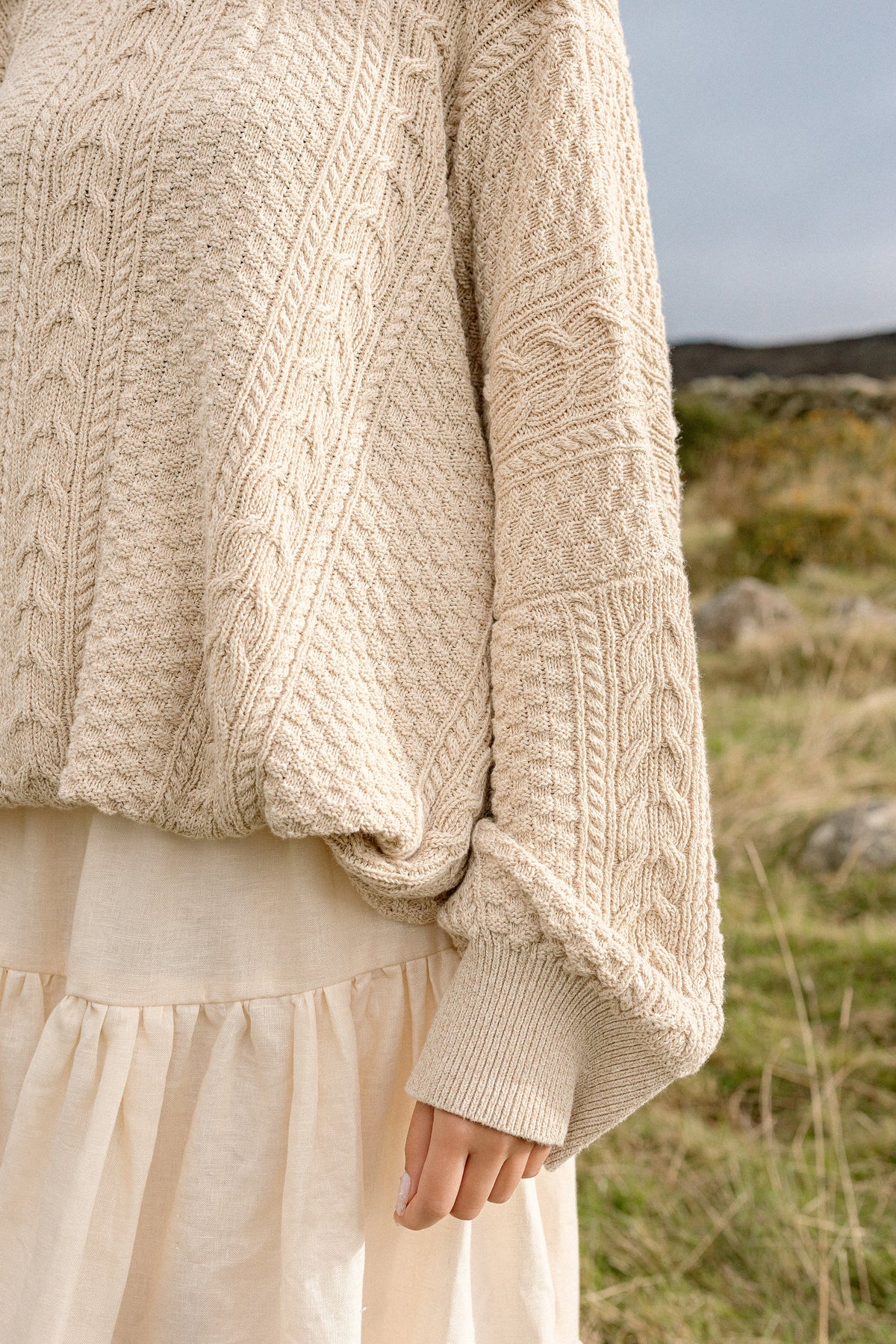 The full sleeve and ribbed cuff of the Kindred Aran jumper