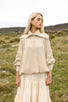 The Aran Jumper, a cream cable knit with a wide crochet-edged collar