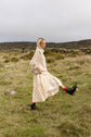 The Aran Jumper in movement, walking through long grass