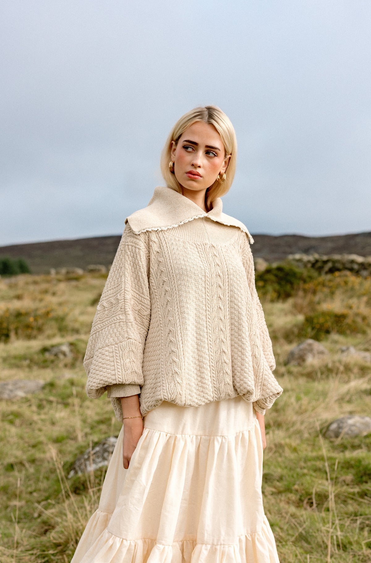 The Aran Jumper worn on a hillside