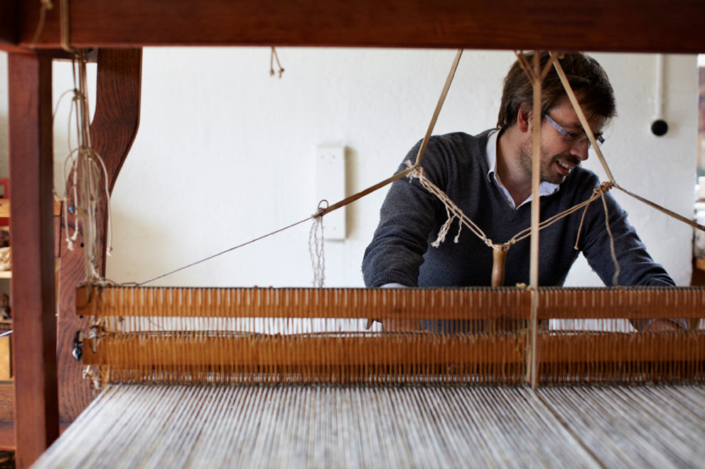 A weaver at a wooden loom in the Mourne Textiles workshop. Photograph: Mourne Textiles.