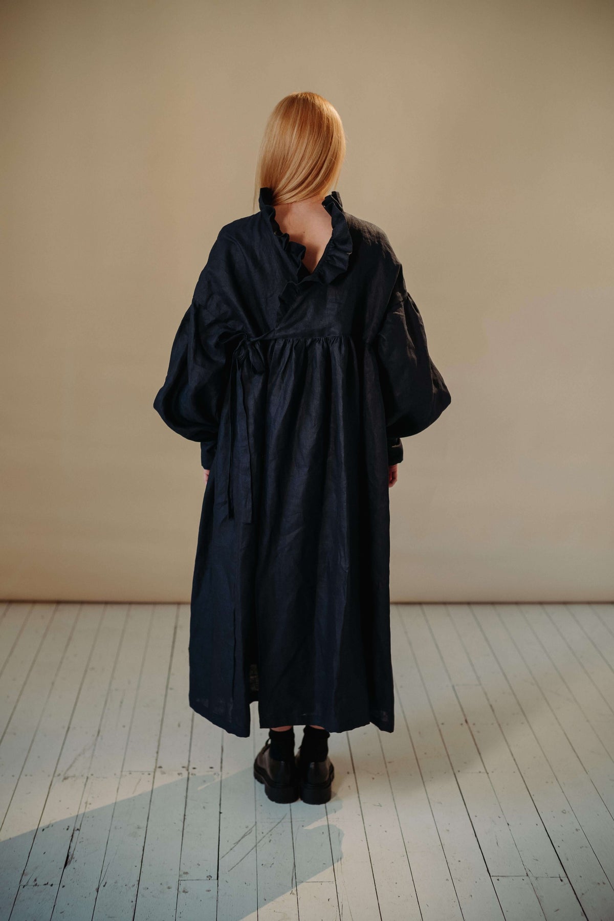 CAMILLE DRESS | NAVY | She has become one of our signature pieces, so we thought it only right to offer a wintery navy version. Camille is a delight to wear. A wrap dress that features a ruffle collar, balloon sleeves and a bow cuff detail. The dress can