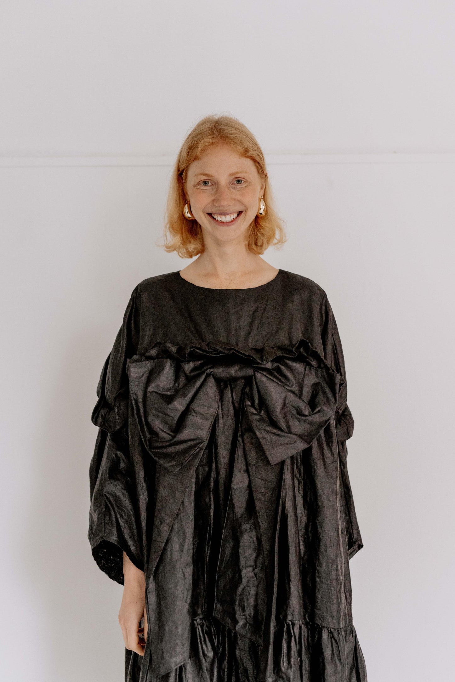 BOW DRESS | BLACK BEETLED | Our one stop, maximum impact party season dress. Based on the silhouette of our Leila dress, we have added length for a more dramatic shape. The black beetled linen gives a unique sheen that gives this dress such a fun edge. An