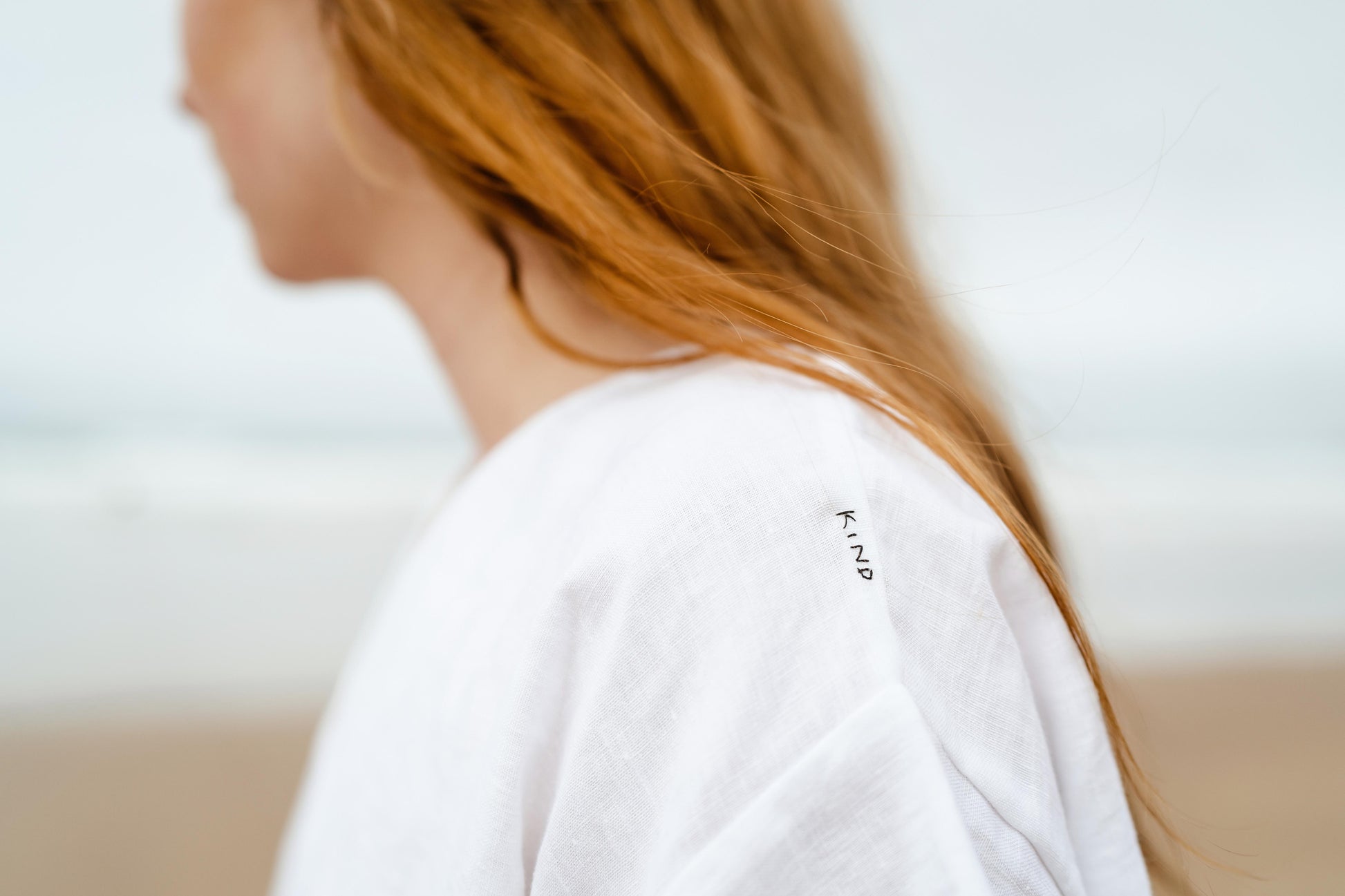 KIND TEE | WHITE | It's cool to be Kind Kind, the first four letters of our brand name - and what we hope to embody! The Kind Tee is a classic staple. Wear with 'V' at front or at the back for a higher neck line- a perfect layering piece. The tee features