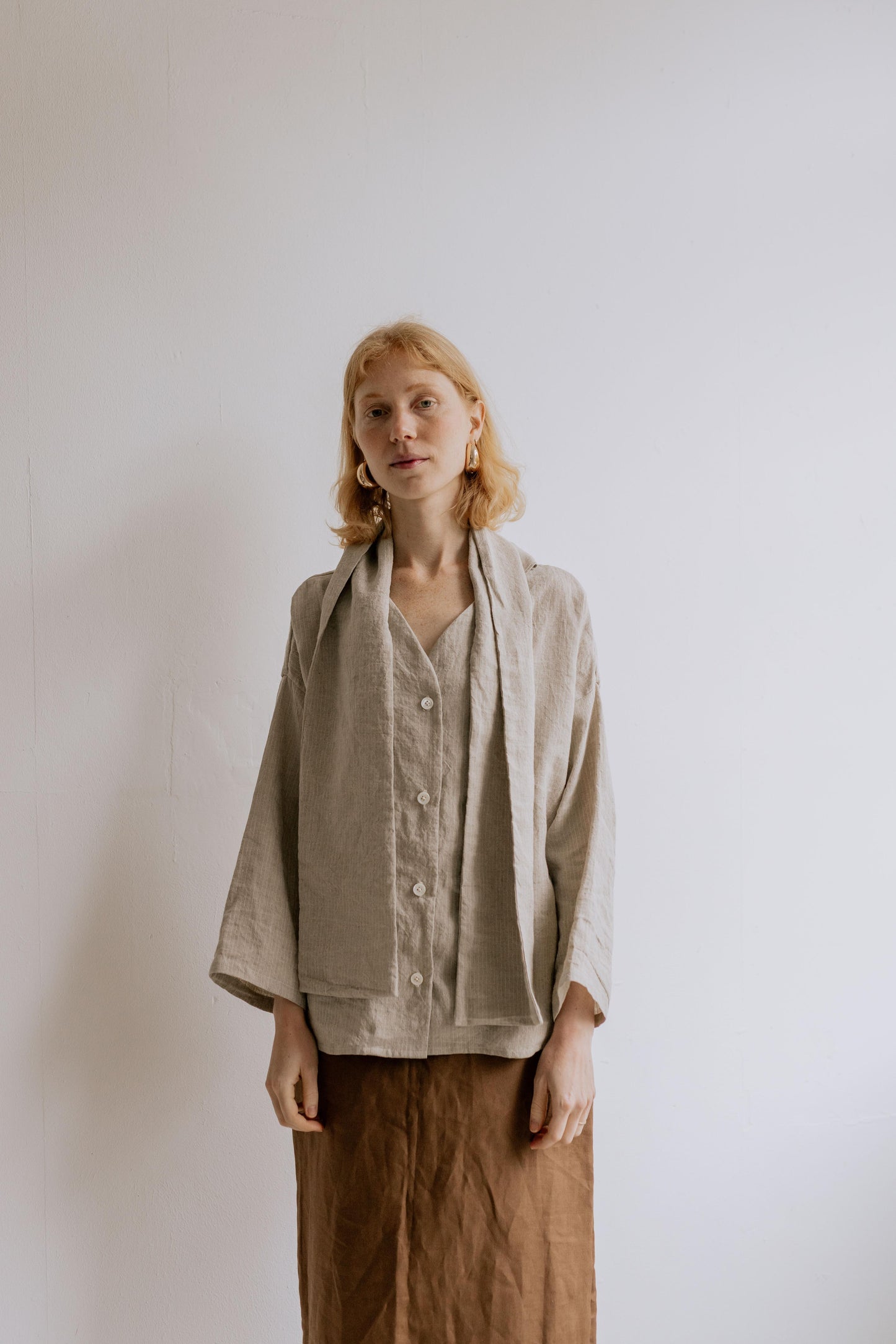 FREYA | STRIPE | Our much loved Freya Blouse in an updated brown/white stripe colour way. The shirt has an oversized collar that is secured with a tie at the back. You can play around with how the collar folds to suit your own look. In keeping with the ve
