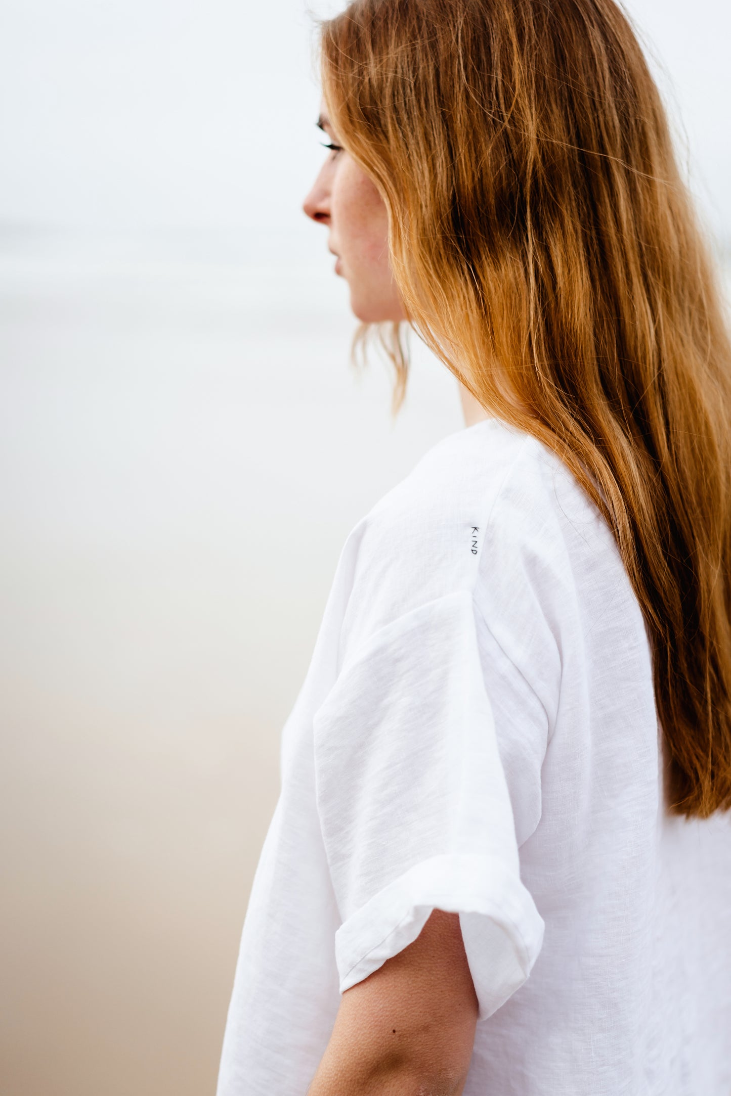 KIND TEE | WHITE | It's cool to be Kind Kind, the first four letters of our brand name - and what we hope to embody! The Kind Tee is a classic staple. Wear with 'V' at front or at the back for a higher neck line- a perfect layering piece. The tee features