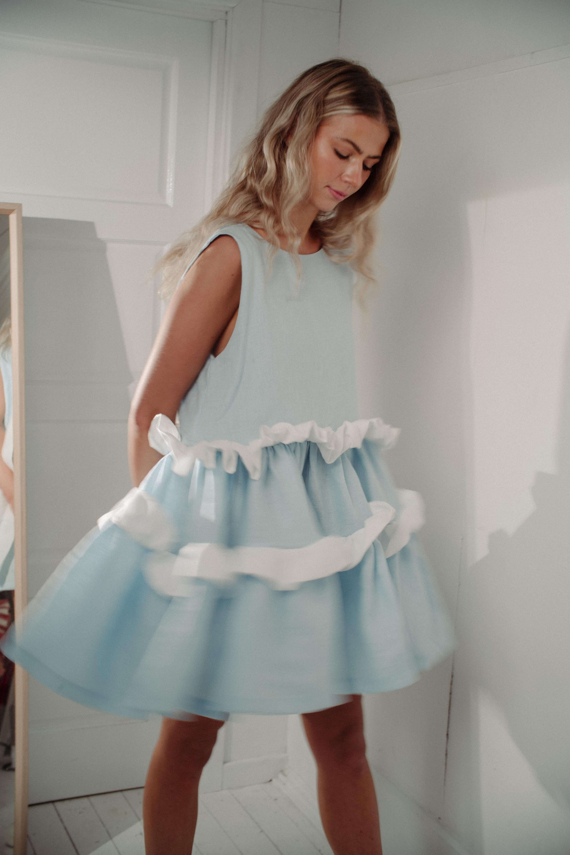 'HEAD IN THE CLOUDS' DRESS | Introducing our most fun piece yet- the 'Head In The Clouds' dress will make you feel like you're floating above the real world. Created with a soft pastel blue linen and contrasting white frill, the dress feels nostalgic and