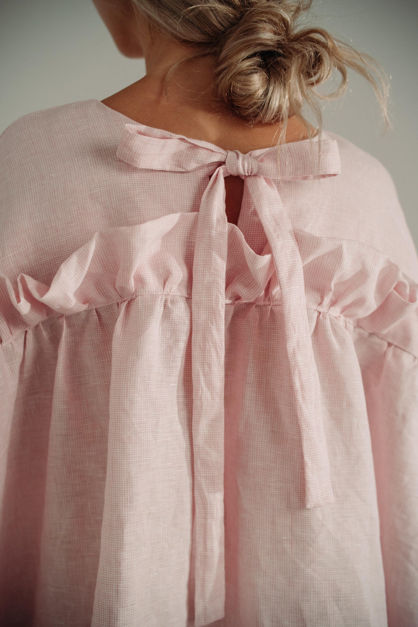LEILA MINI DRESS | PINK | A new silhouette for Spring/Summer. The Leila dress is a fun 'baby doll' style which features our signature 'puff' frill and ties in a delicate bow at the back. Created with a soft pink/white check linen, this dress is the perfec